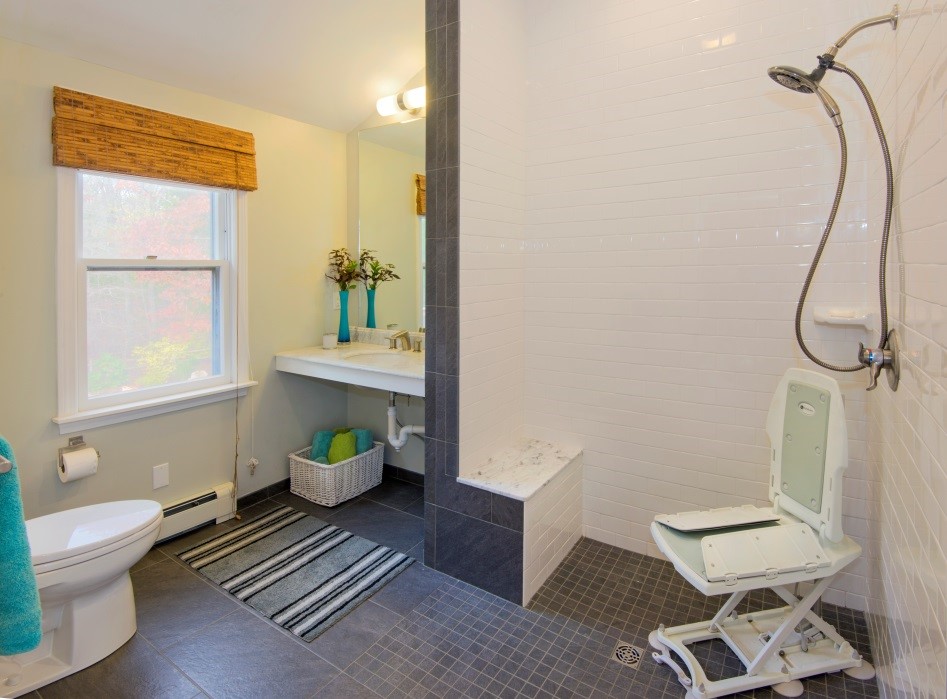 Image of an accessible bathroom in Sandwich featuring a curbless shower and additional space for medical equipment